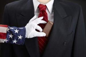 Close up shot of Uncle Sam picking the pocket of a businessman