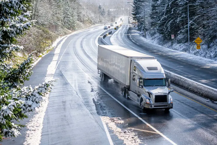 semi truck driving in the winter