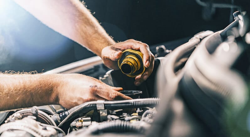 man performing maintenance on a vehicle