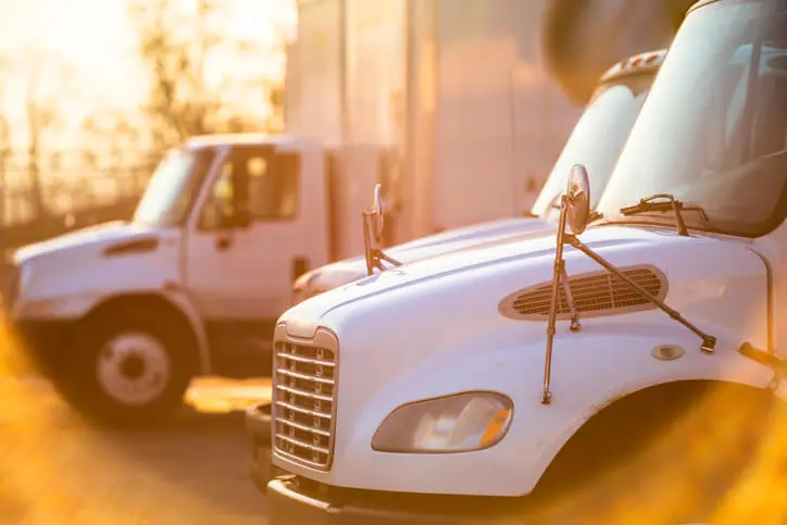 close up of a semi truck with another truck in the background